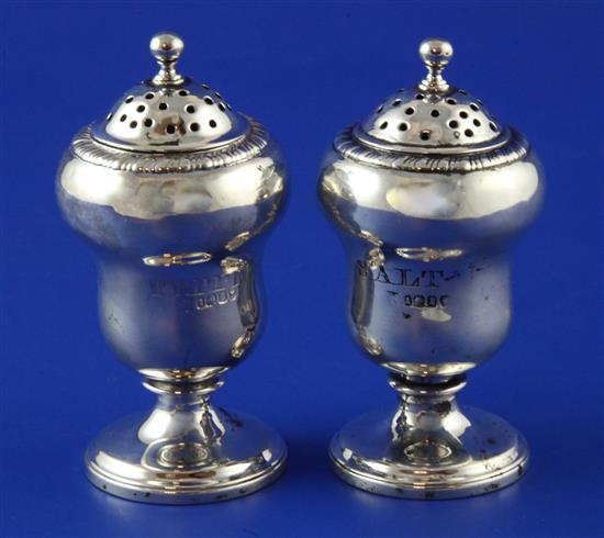 A pair of William IV silver pedestal salt and pepper pots, 3.5in.